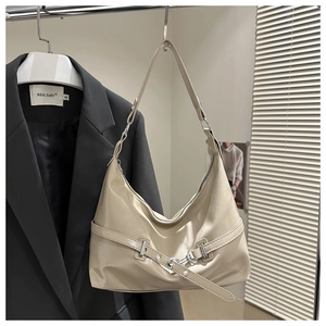 Detailed close-up of cream beige PU leather shoulder bag with sleek metallic buckle and strap