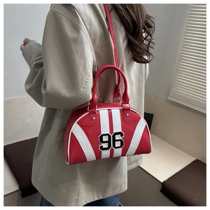 Detail view of red bowling bag with '96' embroidery and star rivet on casual crossbody strap