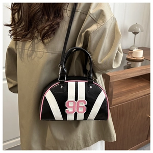 Detailed side view of black retro bowling bag with 96 embroidery and pink piping