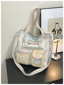 Detail view of colorful multi-pocket tote bag with durable canvas and artistic embroidery