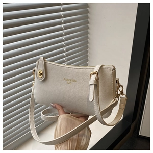White minimalist lychee pattern crossbody pillow bag with gold hardware and logo