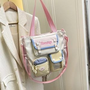 Pastel colorblock nylon tote bag with multiple pockets and adjustable shoulder strap
