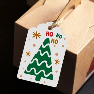 White Christmas gift tags with green tree and HO HO HO text on kraft paper box