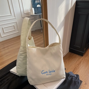 Cream canvas tote bag with blue C'est la vie embroidery for autumn winter fashion