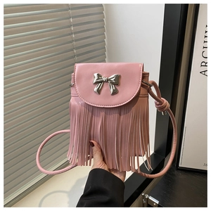 Detail of pink tassel crossbody bag featuring silver bow metal buckle and fringe