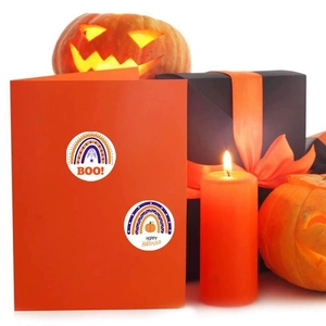 Rainbow and pumpkin Halloween stickers on gift boxes with candles in festive scene