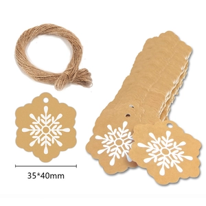 Macro shot of snowflake kraft paper gift tags 35x40mm with twine for Christmas wrapping