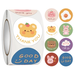 Macro view of cartoon bear and pig reward stickers with Thank You and Good Day text