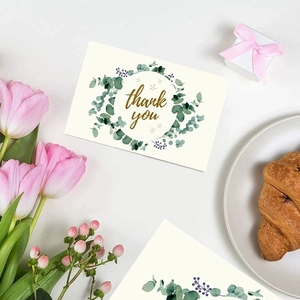 Minimalist white eucalyptus thank you card with gold text and floral wreath decoration