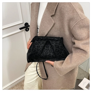 Detail of black velvet cloud bag with leopard print and elegant pleated texture