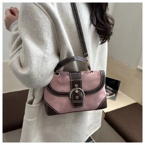 Pink frosted fabric crossbody bag with brown leather trim and golden horseshoe buckle detail