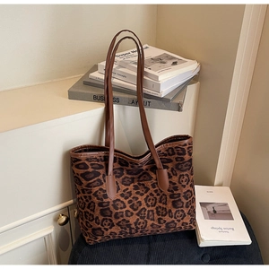 Detail view of large leopard print tote bag with premium faux leather shoulder straps