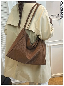 Leopard print tote bag worn with beige trench coat showing spacious interior and daily fit