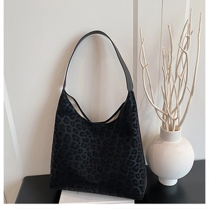 Detailed view of leopard print hobo bag with sleek black leather shoulder strap