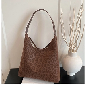 Detail of retro leopard print hobo tote bag with soft texture and leather strap