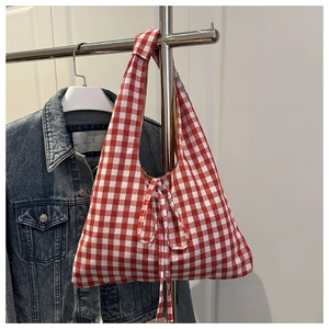 Close-up of red and white gingham canvas tote bag featuring a decorative knot and bow tie