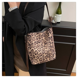 Leopard print tote bag shown on model with adjustable strap and vintage suede texture