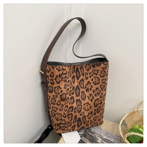 Close-up of leopard print suede bucket bag with adjustable leather strap detail