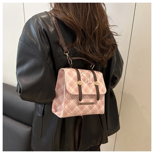 Detail of pink plaid bag with cartoon bear print and premium brown leather handle