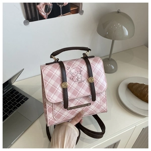 Detail of pink plaid pattern mini backpack with cute dog graphic and gold hardware