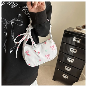 Detail of floral armpit bag with pink rose patterns and pleated handle for women
