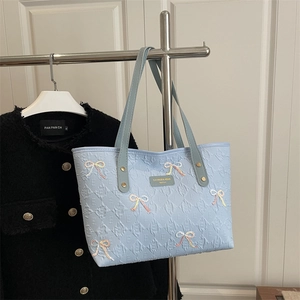 Light blue PU leather tote bag with embossed textures and sequined bow decorations