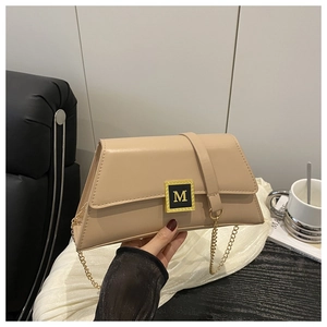 Detail view of the beige leather shoulder bag showing the gold M-buckle and metal chain