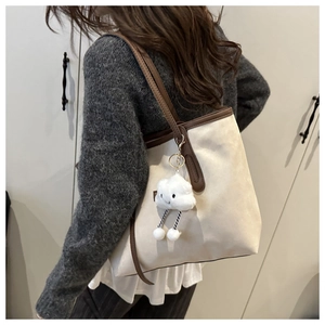 Detail of retro large capacity tote bag featuring beige suede and brown shoulder straps