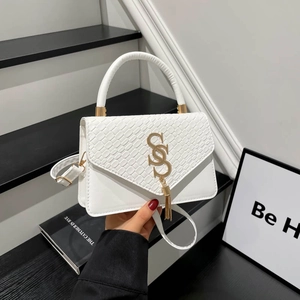 White patchwork crossbody bag with crocodile pattern flap and golden S-logo charm