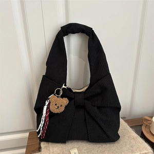 Black corduroy shoulder bag with 3D bow design and cute brown plush bear charm