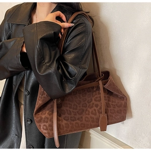 Close-up of leopard print tote bag with premium faux suede texture and leather straps