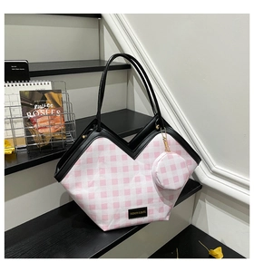 Detail view of pink plaid tote bag with V-shaped opening and mini zipper pouch accessory
