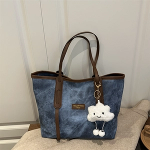 Retro denim tote bag with brown leather trim and cute white cloud pendant decoration