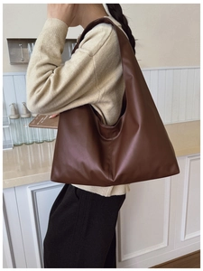 Deep brown faux leather tote bag showing spacious capacity and wide shoulder strap