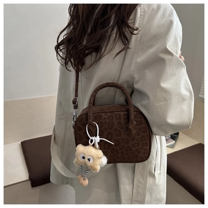 Brown leopard print Boston bag detail with plush charm and detachable shoulder strap