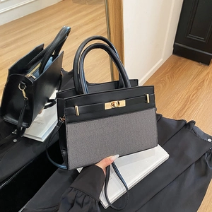 Two-tone contrast handbag with black leather and gray woven texture with gold buckle