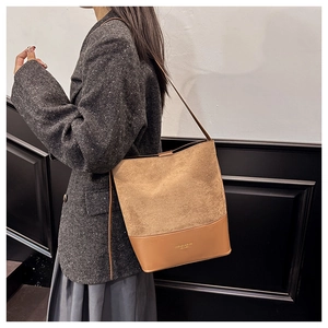 Detail of caramel suede and smooth leather bucket bag with gold printed logo