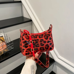 Leopard print underarm bag with bold red resin chain and glossy finish shoulder strap