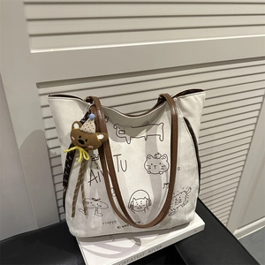 Retro cream canvas tote bag with cartoon illustrations, brown straps and bear keychain