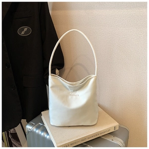 Detail of white minimalist underarm bag with hope and future embroidery texture
