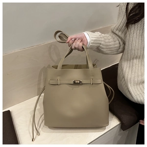 Vue détaillée du sac seau kaki avec fermoir doré décoratif et bandoulière réglable