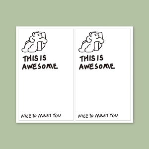 Detail of white square stickers with minimalist cartoon character and black typography