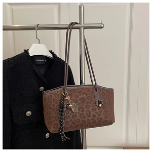 Détail du sac cabas imprimé léopard avec lettrage fashion et breloque raquette de tennis
