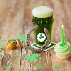 Vintage horseshoe metal decor with lucky shamrock on St. Patrick's Day themed wood table