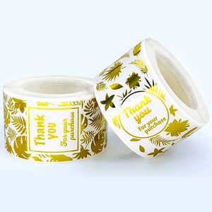 Roll of white and gold Thank You stickers with elegant tropical palm leaf designs
