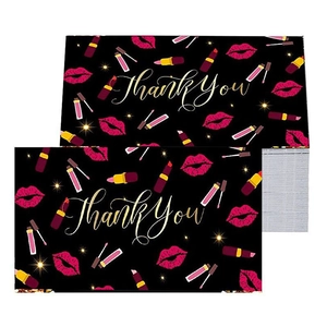 Detail of stacked Thank You cards featuring red lips, gold lipstick, and stars on black background