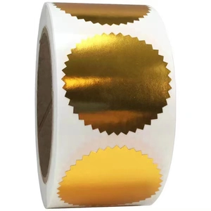 Close-up of golden serrated wafer seals on a roll with a metallic reflective finish