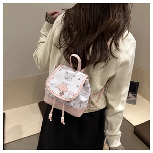 Mini floral backpack with pink and white contrast, shown on a model's back