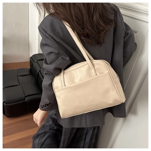 Top view of cream white PU leather hobo bag with double straps and front pocket detail