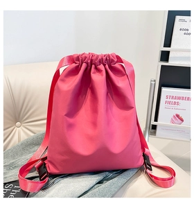 Detail of rose pink nylon drawstring backpack with durable webbing straps and buckle